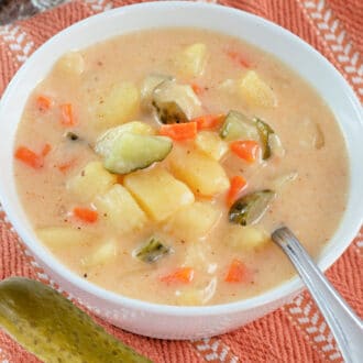 一碗汤，上面有泡菜，胡萝卜和土豆以及咸菜旁边的汤